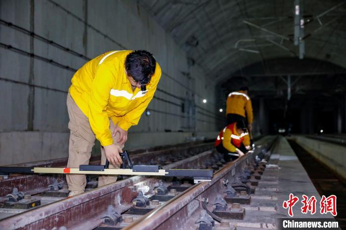 中國鐵路南寧局集團有限公司南寧工務(wù)段職工使用道尺檢查吳圩機場高鐵站高鐵線路設(shè)備?！№f剛 攝
